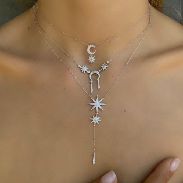 An 18ct gold necklace, set with approximately 0.37ct of white diamonds. Moon Measures 12mm diameter and Star Measure 7mm diameter Chain length 16 inches