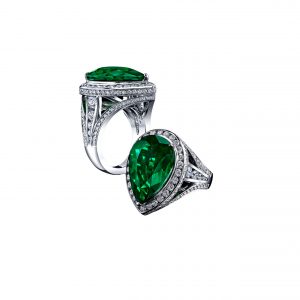 A 5.43ct Pear Shaped natural Emerald ring, set with 2.56ct of Diamonds, in platinum.