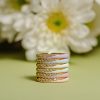 STACK OF PASTEL COLORED DIAMOND RINGS
